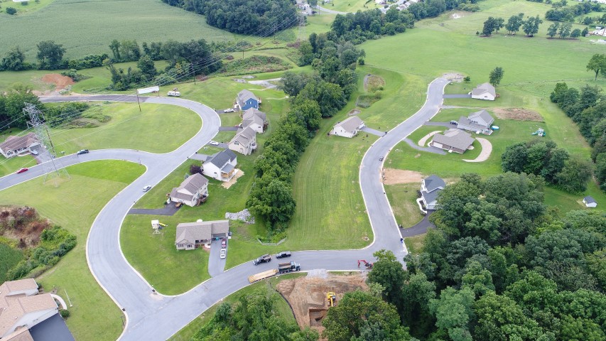 Aerial photo of Homestead Acres showing roads, houses, surrounding fields and trees