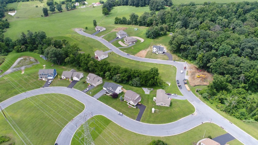 Aerial photo of Homestead Acres showing roads, houses, surrounding fields and trees