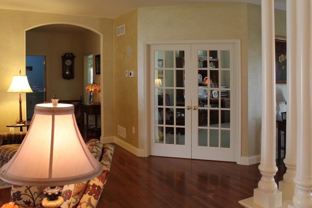 Beautiful interior French doors, hardwood flooring, interior columns, arched opening to the left