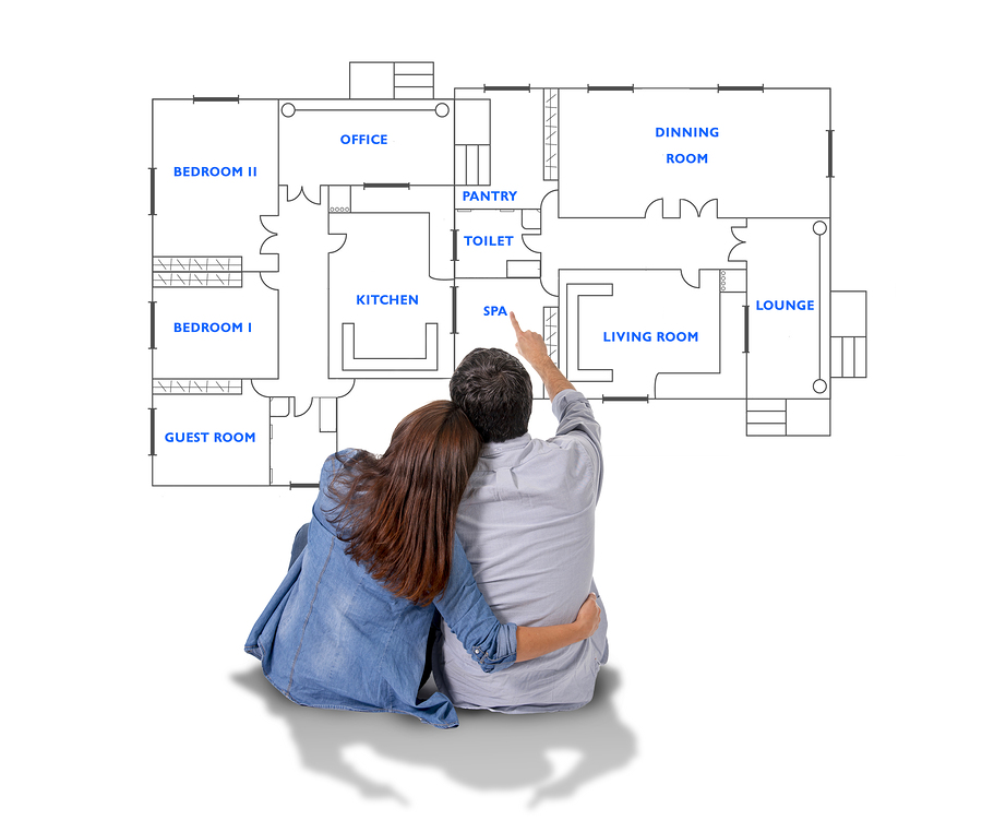 Young happy couple together planning dream home and pointing at blueprints/floor plan and design of new house