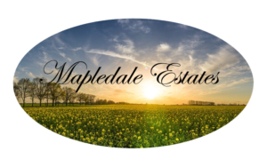 logo for mapledale estates shows community name over beautiful open field with rising sun in background